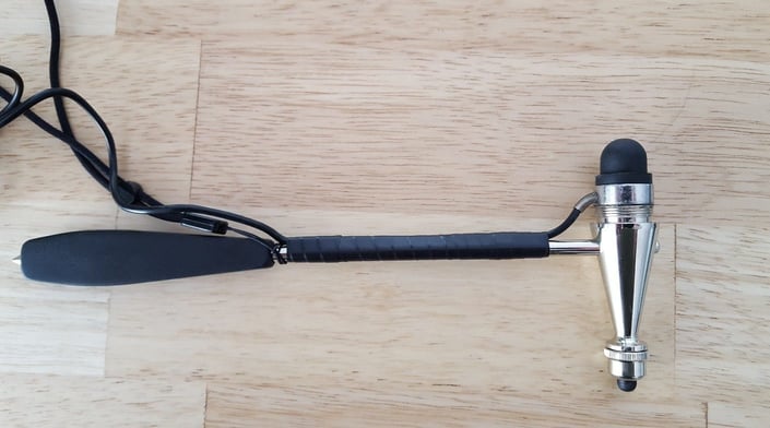 photo of a reflex hammer used by doctors. this one is retrofitted with a small load button to measure the force applied to the body part 