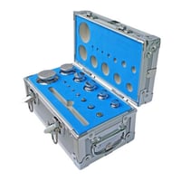 A photo of ANYLOAD TWSF1 Complete Stainless Steel Test Weight Set, F1 Grade. It shows a steel case with blue protective insert in both the base and lid, with steel test weights inside the protective insert hollows.