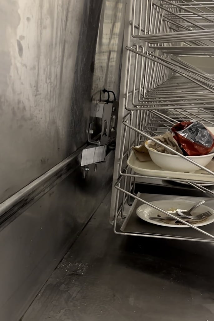 photo of university of the pacific food tray return system with ramp along wheel track to guide loads toward the load point of load cells measuring tray system weight